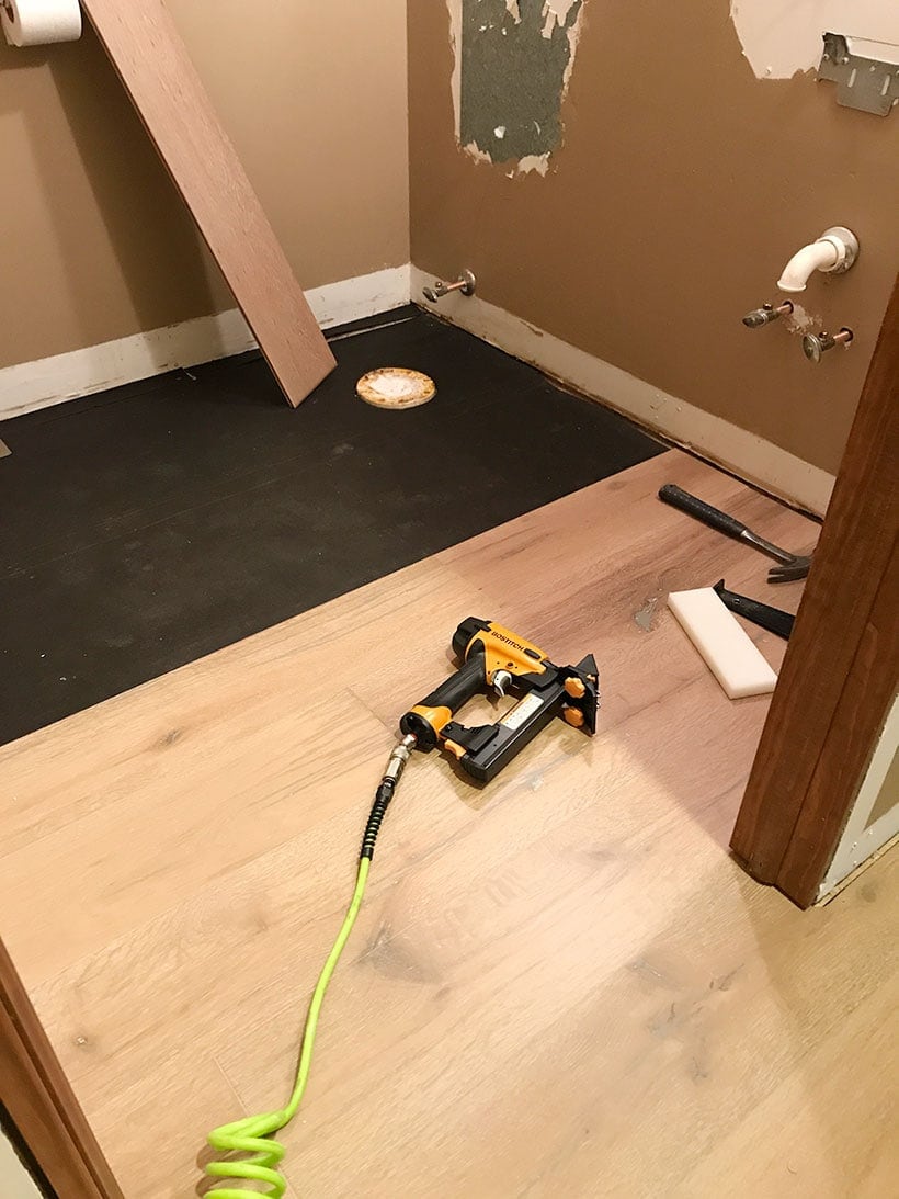 installing white oak engineered hardwood floors in powder bathroom | #bathremodel #bathdesign