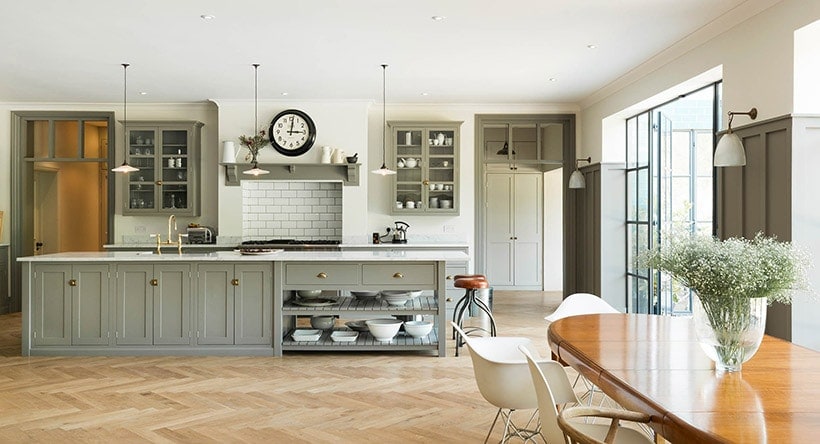 herringbone wood floor with gray shaker kitchen cabinets | design by DeVol Kitchens