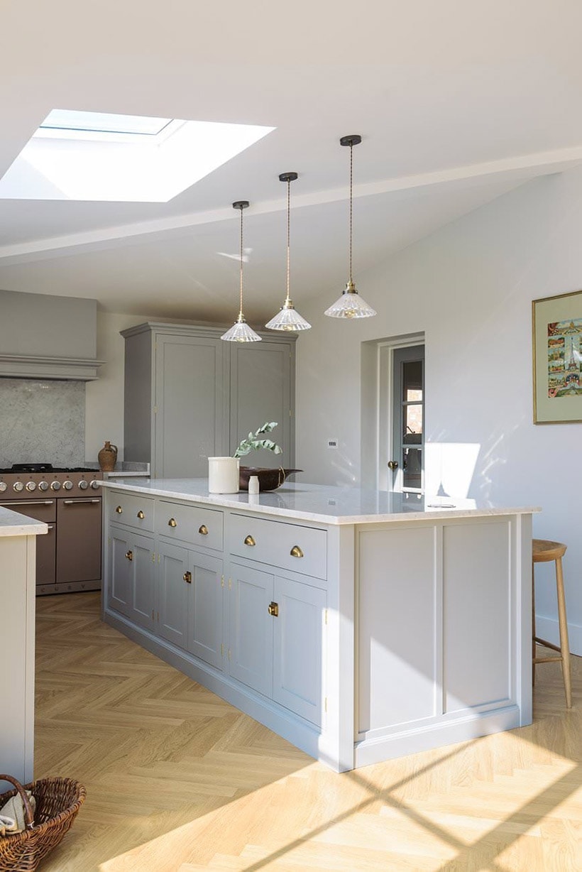 herringbone wood floor with gray shaker kitchen cabinets | design by deVOL Kitchens