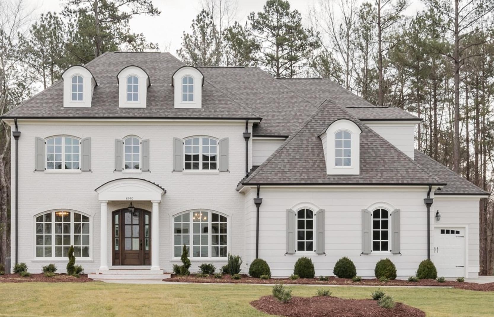 traditional home with agreeable gray exterior and bm white dove trim